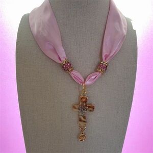Cross scarf pendant on a pink satin feel scarf